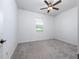 Carpeted bedroom with a ceiling fan and window providing natural light at 10446 Tupper Cay Dr, San Antonio, FL 33576