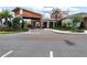 Stunning clubhouse entrance featuring modern architecture, lush landscaping, and a welcoming drive-up at 10446 Tupper Cay Dr, San Antonio, FL 33576