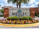 Medley at Mirada community sign with colorful flowerbeds adding to the welcoming curb appeal at 10446 Tupper Cay Dr, San Antonio, FL 33576