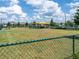 Fenced dog park with covered seating, green space, and play structures for pets to enjoy at 10446 Tupper Cay Dr, San Antonio, FL 33576