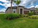 Well-maintained single-story home featuring a manicured lawn and tidy landscaping at 10446 Tupper Cay Dr, San Antonio, FL 33576