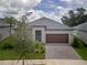 Charming single-story home featuring a well-maintained lawn, two-car garage, and neutral color scheme at 10446 Tupper Cay Dr, San Antonio, FL 33576