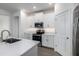 Well-equipped kitchen boasting white cabinets, stainless steel appliances, and sleek countertops at 10446 Tupper Cay Dr, San Antonio, FL 33576
