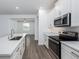 Modern kitchen with white countertops and cabinets, featuring stainless steel appliances at 10446 Tupper Cay Dr, San Antonio, FL 33576