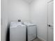 Laundry room with a white washer and dryer at 10446 Tupper Cay Dr, San Antonio, FL 33576