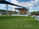Inviting lawn area featuring an outdoor stage, perfect for community events, complete with seating and recreational space at 10446 Tupper Cay Dr, San Antonio, FL 33576