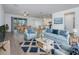 Bright living room with stylish furniture, wood-look tile floors, and an open floor plan at 10446 Tupper Cay Dr, San Antonio, FL 33576