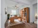 Bright home office with built-in bookshelves, a ceiling fan, and a large window with great natural light at 10446 Tupper Cay Dr, San Antonio, FL 33576