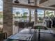 Relaxing poolside bar area with comfortable seating, bar, and refreshing views of the pool and palm trees at 10446 Tupper Cay Dr, San Antonio, FL 33576