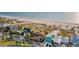 Aerial view of beachfront homes close to the ocean and a sandy beach at 1058 Eldorado Ave, Clearwater Beach, FL 33767