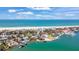 Breathtaking aerial view of waterfront homes, marina, and beach in a vibrant coastal community at 1058 Eldorado Ave, Clearwater Beach, FL 33767
