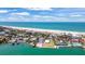 Gorgeous aerial view of a coastal community with a beach, marina, and stunning turquoise waters at 1058 Eldorado Ave, Clearwater Beach, FL 33767