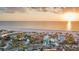Beautiful aerial view of a sunset over beachside homes with manicured landscaping at 1058 Eldorado Ave, Clearwater Beach, FL 33767