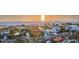 Charming beachfront homes with lush greenery and picturesque ocean views at sunset at 1058 Eldorado Ave, Clearwater Beach, FL 33767