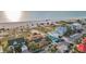 This high angle view features beachfront houses near the ocean with a beautiful sandy beach at 1058 Eldorado Ave, Clearwater Beach, FL 33767