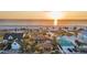 Beautiful beach homes with lush landscaping and ocean views at sunset at 1058 Eldorado Ave, Clearwater Beach, FL 33767