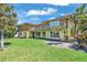 The home's lush backyard features large windows, a covered patio, and a well-maintained lawn, perfect for outdoor enjoyment at 1058 Eldorado Ave, Clearwater Beach, FL 33767