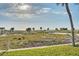 Beach access with lush greenery and views of the ocean and horizon in the distance at 1058 Eldorado Ave, Clearwater Beach, FL 33767