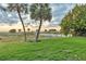 Scenic view of palm trees and soft sand beach from the grassy lawn at 1058 Eldorado Ave, Clearwater Beach, FL 33767