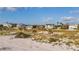 Beachfront property with sandy dunes and scattered palm trees, offering serene coastal living at 1058 Eldorado Ave, Clearwater Beach, FL 33767