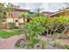 Charming townhome with lush landscaping, a brick walkway, and a welcoming tropical ambiance at 1058 Eldorado Ave, Clearwater Beach, FL 33767