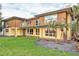 A bright two-story home with balconies, large windows, and lush green lawn at 1058 Eldorado Ave, Clearwater Beach, FL 33767