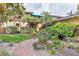 Charming townhome with lush landscaping, a brick walkway, and a welcoming tropical ambiance at 1058 Eldorado Ave, Clearwater Beach, FL 33767
