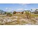 Exterior shot of beachfront homes and a wide open sandy area great for outdoor enjoyment at 1058 Eldorado Ave, Clearwater Beach, FL 33767