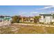 Spacious two-story home with a well-maintained lawn and palm trees, nestled along the beachfront at 1058 Eldorado Ave, Clearwater Beach, FL 33767