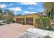 A two-car garage with a brick driveway, complemented by vibrant landscaping and a well-maintained exterior at 1058 Eldorado Ave, Clearwater Beach, FL 33767