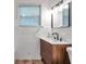Stylish bathroom with a wood vanity, black hardware, and white tile at 1069 21St N Ave, St Petersburg, FL 33704