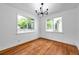 Bright dining room features hardwood floors, two windows, and modern chandelier at 1069 21St N Ave, St Petersburg, FL 33704