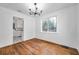 Dining room with hardwood floors, modern chandelier, and view into kitchen at 1069 21St N Ave, St Petersburg, FL 33704