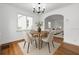 Cozy dining area with modern lighting, archway leading to the living room, and wood floors at 1069 21St N Ave, St Petersburg, FL 33704
