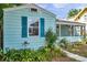 View of the home featuring light-blue wood siding, blue shutters and a screened-in porch at 1069 21St N Ave, St Petersburg, FL 33704