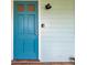 Close-up of the bright blue front door, light fixture, and exterior at 1069 21St N Ave, St Petersburg, FL 33704