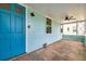 View of the front porch with stone floor, ceiling fan, and blue front door at 1069 21St N Ave, St Petersburg, FL 33704