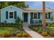 Charming single-story home with lush landscaping, beautiful flower beds, and inviting front porch at 1069 21St N Ave, St Petersburg, FL 33704