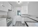 Classic kitchen featuring white cabinets, retro appliances, and patterned tile flooring at 1069 21St N Ave, St Petersburg, FL 33704