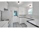 Charming kitchen with white cabinets, black and white tile flooring, and vintage appliances at 1069 21St N Ave, St Petersburg, FL 33704