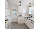 Well-lit kitchen featuring white cabinets, black hardware, and elegant patterned tile flooring at 1069 21St N Ave, St Petersburg, FL 33704