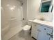 Clean bathroom features a shower-tub combo with white fixtures, vanity with sink and a tiled floor at 107 Caldwell Dr # 178M, Brandon, FL 33510