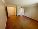 Bedroom view with wood flooring and open closet with double doors and overhead lighting at 107 Caldwell Dr # 178M, Brandon, FL 33510