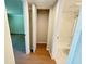 Hallway view with closet featuring louvered doors and doorway to the bathroom with a tiled shower at 107 Caldwell Dr # 178M, Brandon, FL 33510