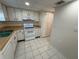 Well-lit kitchen features white appliances and tiled floors at 107 Caldwell Dr # 178M, Brandon, FL 33510
