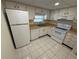 Clean kitchen with white appliances, light wood countertops, and efficient layout at 107 Caldwell Dr # 178M, Brandon, FL 33510