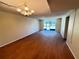 Bright living room featuring hardwood floors, neutral paint, and a vintage chandelier at 107 Caldwell Dr # 178M, Brandon, FL 33510