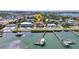 Aerial view showcases the waterfront home with boat docks on the bay, plus neighborhood and beautiful water views at 107 Sunset Dr, Nokomis, FL 34275