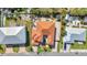 Aerial view of a home with a tile roof, nestled among lush landscaping and neighboring properties at 107 Sunset Dr, Nokomis, FL 34275
