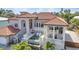 Elegant home featuring a beautiful pool, covered patio, and manicured landscaping, perfect for outdoor living at 107 Sunset Dr, Nokomis, FL 34275